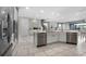Bright kitchen with a large island, quartz countertops, stainless steel appliances, and lots of space at 7665 Fairfax Dr, Kissimmee, FL 34747