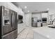 Bright kitchen with a large island, quartz countertops, stainless steel appliances, and white cabinetry at 7665 Fairfax Dr, Kissimmee, FL 34747