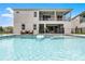 An inviting pool area featuring a private pool, jacuzzi, and outdoor seating, perfect for relaxation and entertaining at 7665 Fairfax Dr, Kissimmee, FL 34747