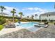 An aerial view of a large pool, spa, and lounge chairs with a basketball hoop on the patio at 7665 Fairfax Dr, Kissimmee, FL 34747