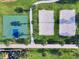 Aerial view of the community's recreation area, with beach volleyball, a basketball court, and walkways at 7665 Fairfax Dr, Kissimmee, FL 34747
