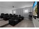 A theater room with tiered seating, projector, and popcorn machine at 7665 Fairfax Dr, Kissimmee, FL 34747