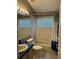 Standard bathroom featuring a tub, shower, toilet, and vanity with tile floor and walls at 8074 Santee Dr, Kissimmee, FL 34747