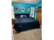 Comfortable blue bedroom featuring a cozy bed and ample natural light at 8074 Santee Dr, Kissimmee, FL 34747