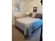 Cozy bedroom with comfortable bed, soft lighting and neutral colored walls at 8074 Santee Dr, Kissimmee, FL 34747