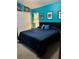 Spacious blue bedroom with comfortable bed and ample natural light and closet at 8074 Santee Dr, Kissimmee, FL 34747