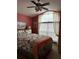A cozy bedroom with a double bed is illuminated by natural light, complemented by charming window treatments and wall art at 8074 Santee Dr, Kissimmee, FL 34747