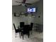 Bright kitchen nook with a ceiling fan, tile flooring, and a mounted TV for dining enjoyment at 8074 Santee Dr, Kissimmee, FL 34747
