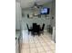 Cozy kitchen area with a glass dining table, ceiling fan, and a wall-mounted TV at 8074 Santee Dr, Kissimmee, FL 34747