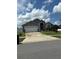 Single Gathering home with manicured lawn and a front-facing two car garage and attractive landscaping at 8074 Santee Dr, Kissimmee, FL 34747