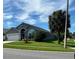 Side view of a single Gathering home, with well-maintained lawn, attractive landscaping, and a palm tree at 8074 Santee Dr, Kissimmee, FL 34747