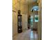 Inviting foyer featuring neutral paint, tile flooring, and an arched transom window at 8074 Santee Dr, Kissimmee, FL 34747