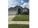 Charming single Gathering home with a well-manicured lawn and attached two-car garage at 8074 Santee Dr, Kissimmee, FL 34747