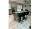 Eat-in kitchen with a gray breakfast bar, tile backsplash, and stainless steel appliances at 8074 Santee Dr, Kissimmee, FL 34747
