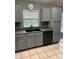 Updated kitchen featuring gray cabinets, black appliances, and a sleek black sink at 8074 Santee Dr, Kissimmee, FL 34747