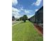 Expansive well-maintained lawn of a single-Gathering home with manicured flower beds at 8074 Santee Dr, Kissimmee, FL 34747