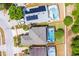 Aerial view of a beautiful home featuring a screened-in pool and solar panels at 814 Bloomingdale Dr, Davenport, FL 33897