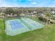 Aerial shot of well-maintained tennis and basketball courts, offering recreational activities within the community at 814 Bloomingdale Dr, Davenport, FL 33897