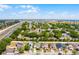 Aerial view of a home within a lush, green community near a highway at 814 Bloomingdale Dr, Davenport, FL 33897