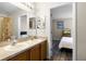 Bathroom featuring a double sink vanity with a view into the bedroom at 814 Bloomingdale Dr, Davenport, FL 33897