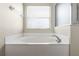 Bathroom featuring tub with window providing natural light at 814 Bloomingdale Dr, Davenport, FL 33897