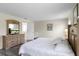 Bedroom features a dresser with TV, light walls, light wood floors, and a crib at 814 Bloomingdale Dr, Davenport, FL 33897