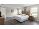 Bedroom with a TV on a dresser, wood flooring, two windows, and an ensuite at 814 Bloomingdale Dr, Davenport, FL 33897