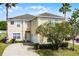 Charming two-story home with a well-manicured lawn and beautiful landscaping at 814 Bloomingdale Dr, Davenport, FL 33897