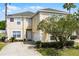 Charming two-story home with a well-manicured lawn and beautiful landscaping at 814 Bloomingdale Dr, Davenport, FL 33897