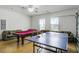 This game room features both a ping pong table and pool table for fun gatherings at 814 Bloomingdale Dr, Davenport, FL 33897