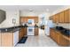 Functional kitchen layout with essential appliances and wooden cabinetry at 814 Bloomingdale Dr, Davenport, FL 33897