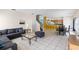 Bright living room with tile flooring, a gray sectional sofa, and an open floor plan leading to the kitchen at 814 Bloomingdale Dr, Davenport, FL 33897