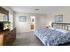 Main bedroom with a king bed, ensuite bathroom, hardwood-style floors, and a dresser with a TV at 814 Bloomingdale Dr, Davenport, FL 33897