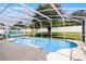 Beautiful pool with spa, covered lanai, plenty of lounge seating, and a white vinyl fence at 814 Bloomingdale Dr, Davenport, FL 33897