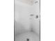 Tiled shower stall features tiled flooring, tiled walls, and adjustable shower head at 814 Bloomingdale Dr, Davenport, FL 33897