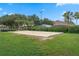 Outdoor sand volleyball court for residents' enjoyment, surrounded by lush landscaping and palm trees at 814 Bloomingdale Dr, Davenport, FL 33897