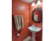 This powder room features bold color and an ornate mirror at 907 Gloucester Ct, Kissimmee, FL 34758
