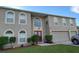 Two story home with large windows and a red double door at 907 Gloucester Ct, Kissimmee, FL 34758