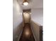 Well-lit hallway featuring wood floors and white walls at 907 Gloucester Ct, Kissimmee, FL 34758