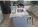 Stylish kitchen island and granite countertops, complemented by stainless steel appliances at 907 Gloucester Ct, Kissimmee, FL 34758