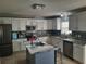 Modern kitchen with granite countertops, stainless steel appliances and a large island at 907 Gloucester Ct, Kissimmee, FL 34758