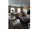 Cozy living room featuring comfortable seating, arched windows, and ample natural light at 907 Gloucester Ct, Kissimmee, FL 34758