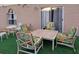 Charming outdoor patio area with tropical-themed furniture and tile table at 907 Gloucester Ct, Kissimmee, FL 34758