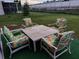 Outdoor patio set with decorative cushions on a well-maintained lawn at 907 Gloucester Ct, Kissimmee, FL 34758