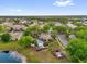 Overhead view of community pool and clubhouse surrounded by lush landscaping in a residential neighborhood at 1225 Coral Coast Dr, Orlando, FL 32824
