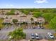 An aerial view of residential buildings showcasing ample parking spaces and well-maintained landscaping at 1225 Coral Coast Dr, Orlando, FL 32824