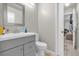 Bathroom with gray vanity, framed mirror, and views to the bedroom with tile floors at 1225 Coral Coast Dr, Orlando, FL 32824