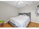 This bedroom boasts laminate floors, ceiling fan, and a gray upholstered bed frame with patterned bedding at 1225 Coral Coast Dr, Orlando, FL 32824