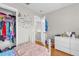 Cozy bedroom featuring laminate flooring, a closet, and a wall decorated with inspirational decals at 1225 Coral Coast Dr, Orlando, FL 32824
