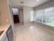 Sunlit dining area features tile floors, large windows with blinds, and stairway access at 1225 Coral Coast Dr, Orlando, FL 32824